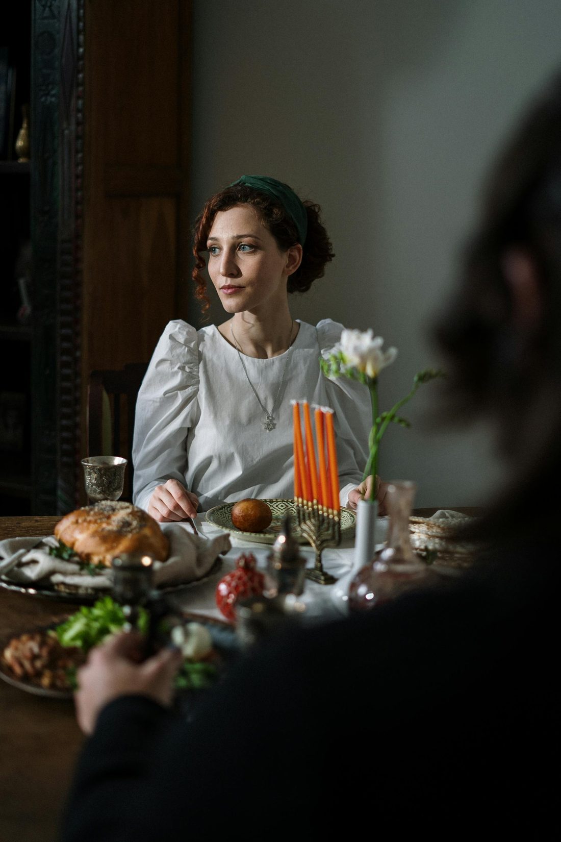 A family Shabbat table set with challah and candles
